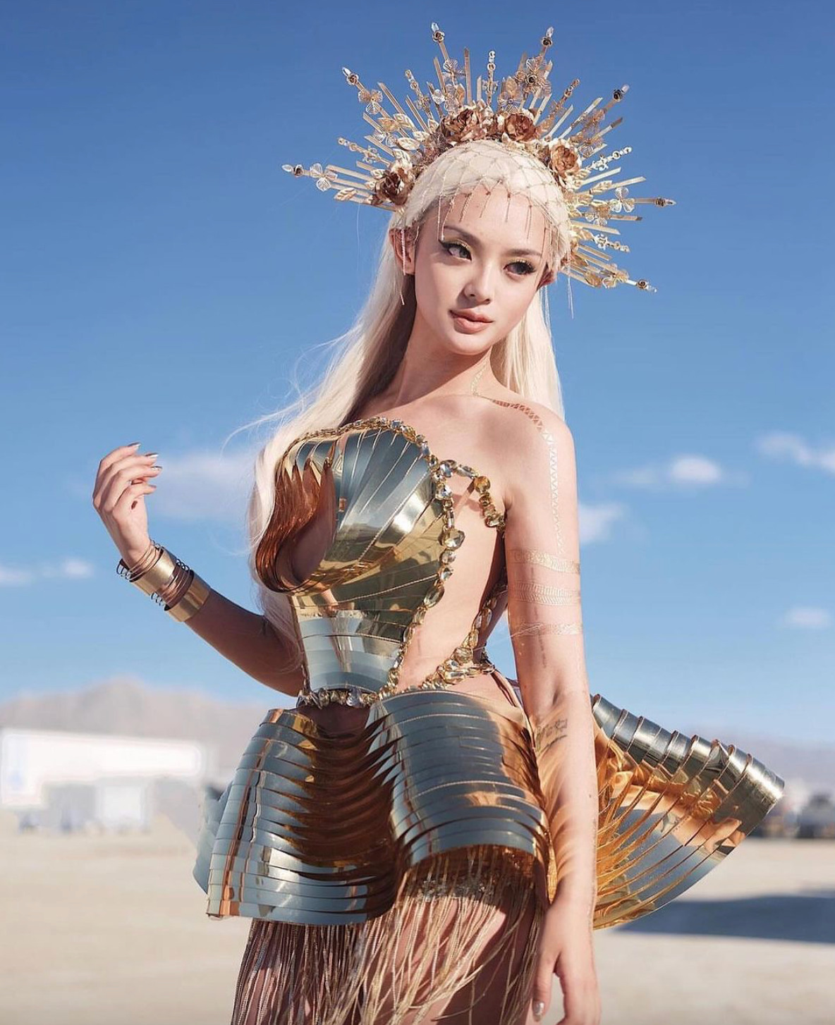 futuristic metallic dress A futuristic dress crafted from layers of intricately laser-cut silver mirror pvc